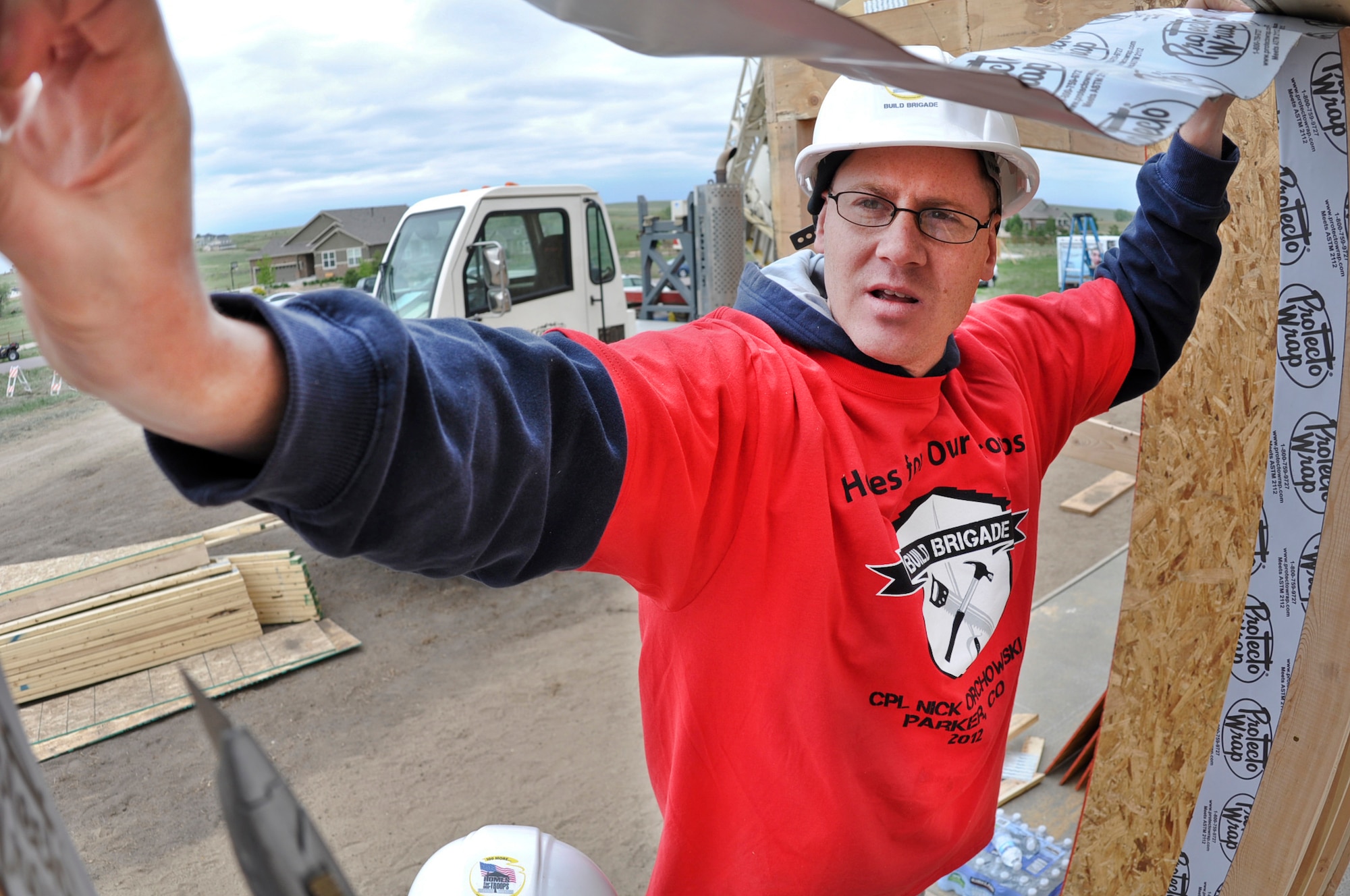 PARKER, Colo. -- Levi Ragan puts up weather stripping before windows are installed on the  home  being constructed for Nick Orchowski, an injured Operation Iraqi Freedom combat veteran, May 11, 2012. Ragan is a staff sergeant attached to Detachment 6 Aerospace Data Facility at Buckley Air Force Base, Colo., and was one of about 60 volunteers from Team Buckley who came out to help with the construction. (U.S. Air Force photo by Senior Airman Christopher Gross)