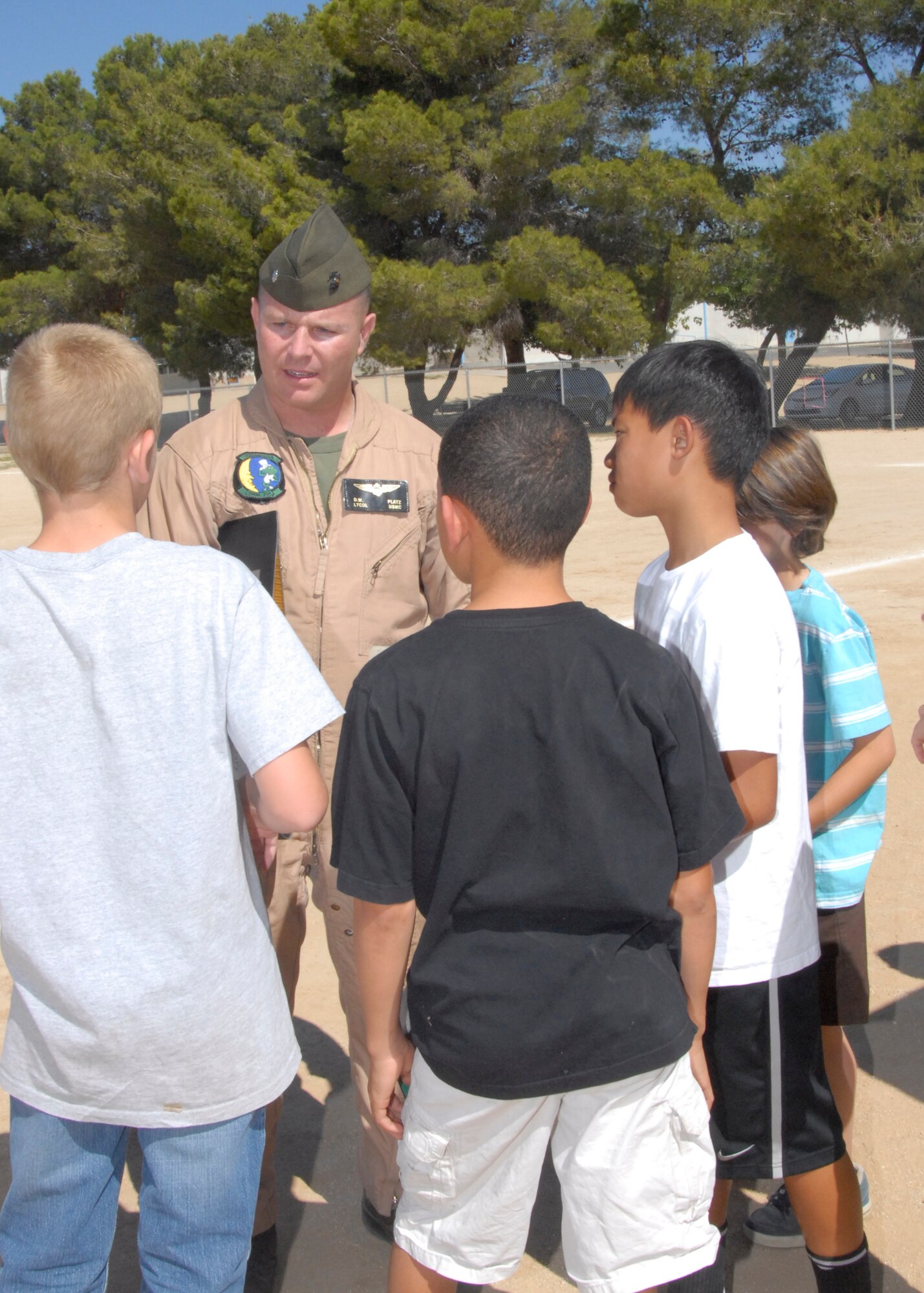 Lt. Col. Darrell W. Platz, Marine Air Group 41, Detachment A commanding officer, talks with Branch Elementary School students during the annual Science Carnival. Before touring the CH-46 Sea Knight helicopter, Platz spoke with students about polymers located throughout the aircraft, as well as the importance of polymers with their gear. (U.S. Air Force Photo by Laura Mowry)