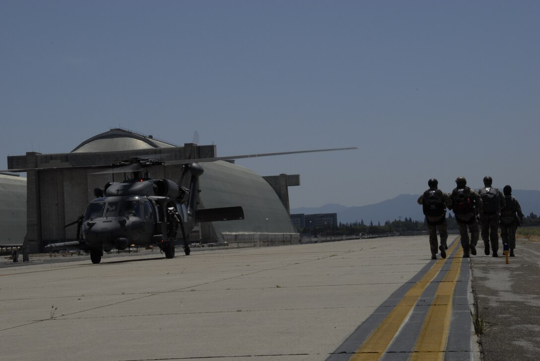 Pararescuemen assigned to the 131st Rescue Squadron prepare to board an HH-60G Pave Hawk rescue helicopter for a training jump at Moffett Federal Airfield, Calif., May 6, 2012. Pararescuemen jumped from various altitudes to conduct static line, freefall, and tandem jumps with personnel and  medical equipment. (Air National Guard photo by Senior Airman Jessica Green)