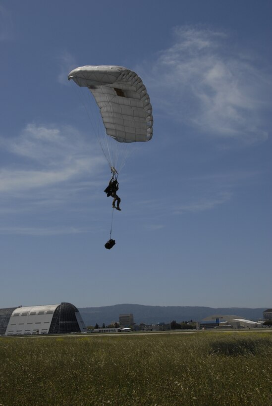 A pararescuemen assigned to the 131st Rescue Squadron approaches a designated drop zone after conducting a static line jump out of an HH-60G Pave Hawk rescue helicopter nearly 10,000 feet above Moffett Federal Airfield, Calif., May 6, 2012. Pararescuemen jumped from various altitudes to conduct static line, freefall, and tandem jumps with personnel and  medical equipment. (Air National Guard photo by Senior Airman Jessica Green)