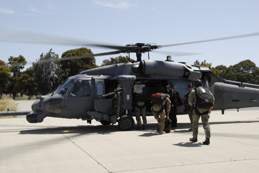 Pararescuemen assigned to the 131st Rescue Squadron prepare to board an HH-60G Pave Hawk rescue helicopter for a training jump at Moffett Federal Airfield, Calif., May 6, 2012. Pararescuemen jumped from various altitudes to conduct static line, freefall, and tandem jumps with personnel and  medical equipment. (Air National Guard photo by Senior Airman Jessica Green)