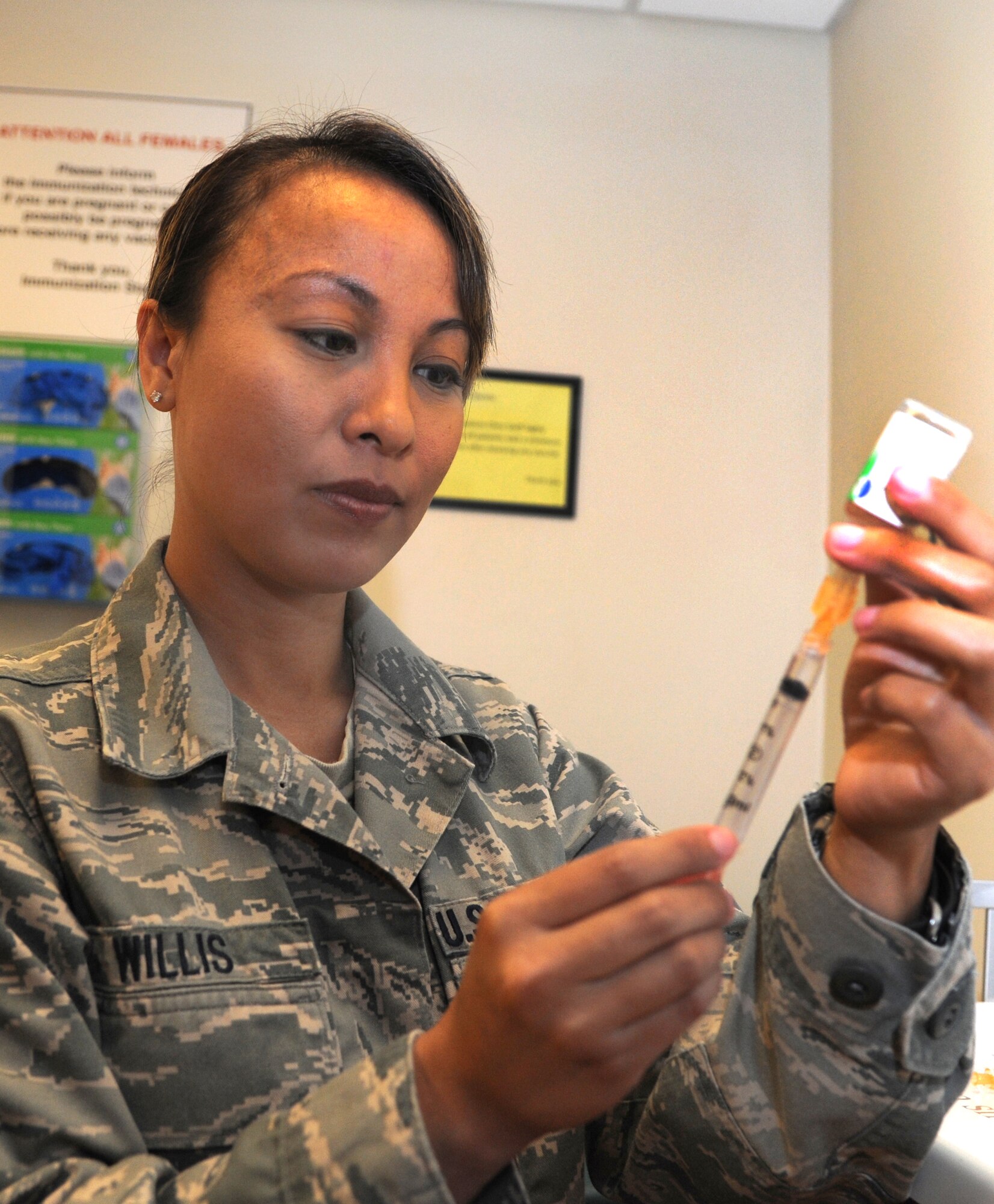 Tech. Sgt. Lorylee Willis, the NCO in charge of the 71st Medical Operations Squadron flight medicine clinic, prepares a typhoid immunization during Nurse and Technician Appreciation Week, May 7-11, at Vance Air Force Base, Okla. (U.S. Air Force photo/ Airman 1st Class Frank John Casciotta)