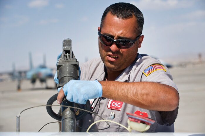 Mark Blackwood, Computer Science Corp. mechanic, Vance Air Force Base, Okla., performs over-the-wing refueling for a T-6A Texan II, 33rd Flying Training Squadron, Vance AFB, Okla., during the Weapons Instructor Course May 8, 2012, at Nellis Air Force Base, Nev. Five T-6A Texan II's participated as opposing forces for the WIC. (U.S. Air Force photo by Staff Sgt. Christopher Hubenthal)