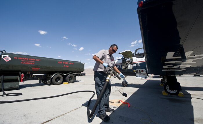 Mark Blackwood, Computer Science Corp. mechanic, Vance Air Force Base, Okla., performs over-the-wing refueling for a T-6A Texan II, 33rd Flying Training Squadron, Vance AFB, Okla., during the Weapons Instructor Course May 8, 2012, at Nellis Air Force Base, Nev. Over-the-wing refueling provides 100 pounds of extra fuel for the aircraft. (U.S. Air Force photo by Staff Sgt. Christopher Hubenthal)