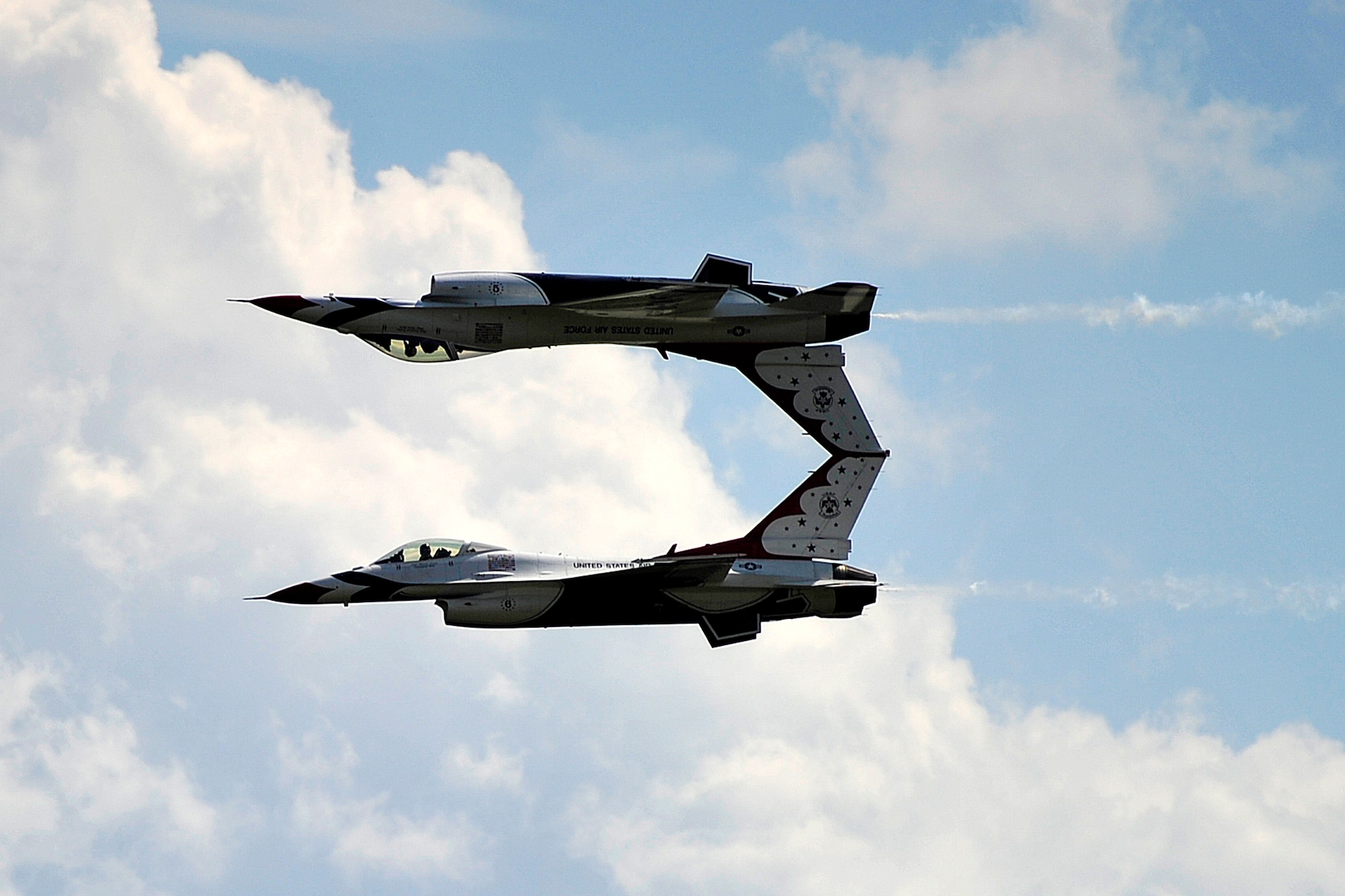Two F-16 Fighting Falcon aircrafts from the U.S. Air Force Thunderbirds, perform an aerial act of precision flying during the Joint Base McGuire-Dix-Lakehurst Open House and Air Show May 12. (U.S. Air Force photo by Tech. Sgt. Parker Gyokeres/Released)