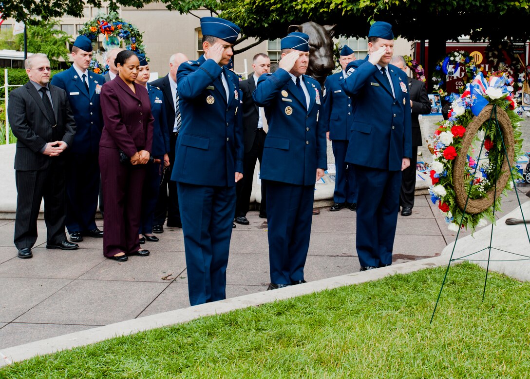 (From left) Col. Humberto Morales, OSI vice commander, Brig. Gen. Kevin Jacobsen, OSI commander, and Chief Master Sgt. John Fine, OSI command chief, salute the wreath placed in honor of OSI's fallen members. The wreath will be displayed at the National Law Enforcement Officers Memorial in Washington, D.C. (U.S. Air Force photo by Mike Hastings.) 