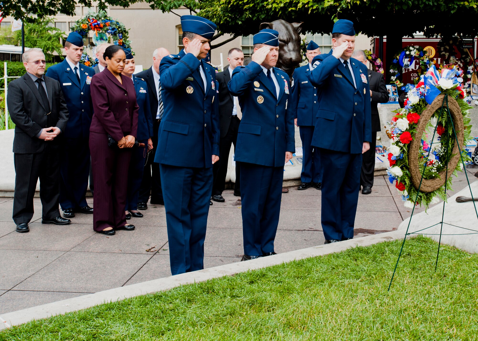 (From left) Col. Humberto Morales, OSI vice commander, Brig. Gen. Kevin Jacobsen, OSI commander, and Chief Master Sgt. John Fine, OSI command chief, salute the wreath placed in honor of OSI's fallen members. The wreath will be displayed at the National Law Enforcement Officers Memorial in Washington, D.C. (U.S. Air Force photo by Mike Hastings.) 
