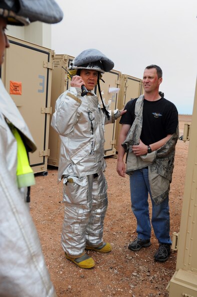 U.S. Air Force Master Sgt. Greg Schaffran, 27th Special Operations Medical Operations Squadron NCOIC of flight medicine, is assisted by an emergency responder for his simulated injuries during a tornado exercise at Cannon Air Force Base, N.M., May 10, 2011. Base personnel practiced various tactics and procedures that would be performed during a real life disaster. (U.S. Air Force photo by Senior Airman Jette Carr)