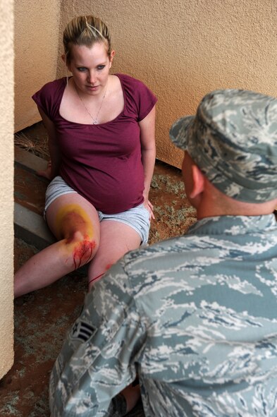 U.S. Air Force 2nd Lt. Elizabeth Seitz, 27th Special Operations Medical Support Squadron, simulates a knee injury during a tornado exercise at Cannon Air Force Base, N.M., May 10, 2011. Base personnel practiced various tactics and procedures that would be performed during a real life disaster. (U.S. Air Force photo by Senior Airman Jette Carr) 