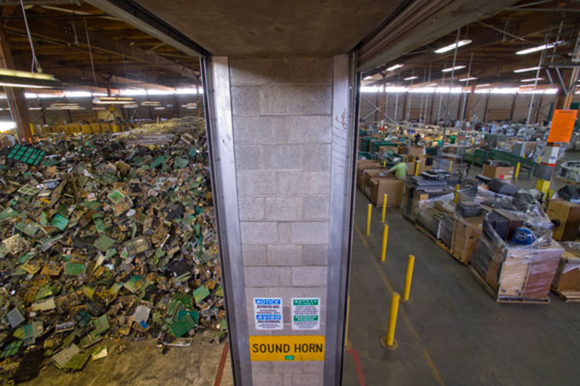 Mountains of e-waste fill a huge storage building at the former Mather Air Force Base, now home to California Electronic Asset Recovery.  CEAR recycled approximately 22 million pounds of e-waste in 2011 and is expanding into a second building at Mather.  (Courtesy photo)
