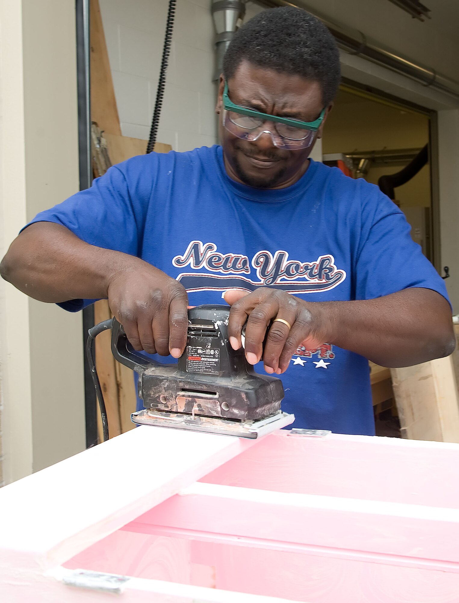 Reggie West sands a cabinet May 9, 2011, at the Arts and Crafts Center on Dover Air Force Base, Del. The A&CC offers wood-working courses at its facility. (U.S. Air Force photo by Adrian R. Rowan)
