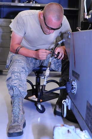 Airman 1st Class Jamie Jones, 437th Maintenance Squadron Aerospace Ground Equipment apprentice, replaces a lanyard for a hinge pin May 7, 2012 at Joint Base Charleston – Air Base. Jones performs scheduled and unscheduled maintenance on aerospace ground equipment. He inspects, tests, and operates AGE to determine equipment serviceability and proper operation.  (U.S. Air Force photo/Airman 1st Class Chacarra Walker)