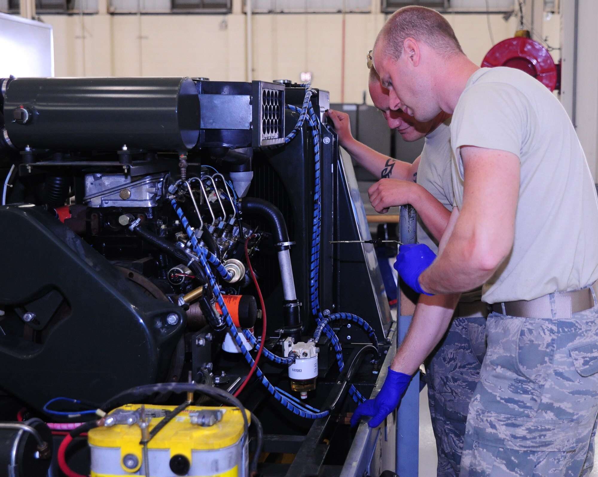 Senior Airman Alexander Ewing, 437th Maintenance Squadron Aerospace Ground Equipment journeyman, and Airman 1st Class Jamie Jones, 437th MXS AGE apprentice, check the oil on a Self-Generating Nitrogen Servicing Cart May 7, 2012 at Joint Base Charleston – Air Base. The SGNSC is intended primarily for flight-line servicing of aircraft, including tire filling, charging, landing struts and charging hydraulic accumulators. (U.S. Air Force photo/Airman 1st Class Chacarra Walker)