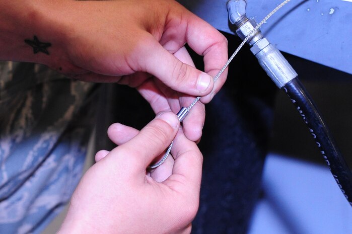Airman 1st Class Jamie Jones, 437th Maintenance Squadron Aerospace Ground Equipment apprentice, replaces a lanyard for a hinge pin May 7, 2012 at Joint Base Charleston – Air Base. Jones performs scheduled and unscheduled maintenance on aerospace ground equipment. He inspects, tests, and operates AGE to determine equipment serviceability and proper operation.  (U.S. Air Force photo/Airman 1st Class Chacarra Walker)