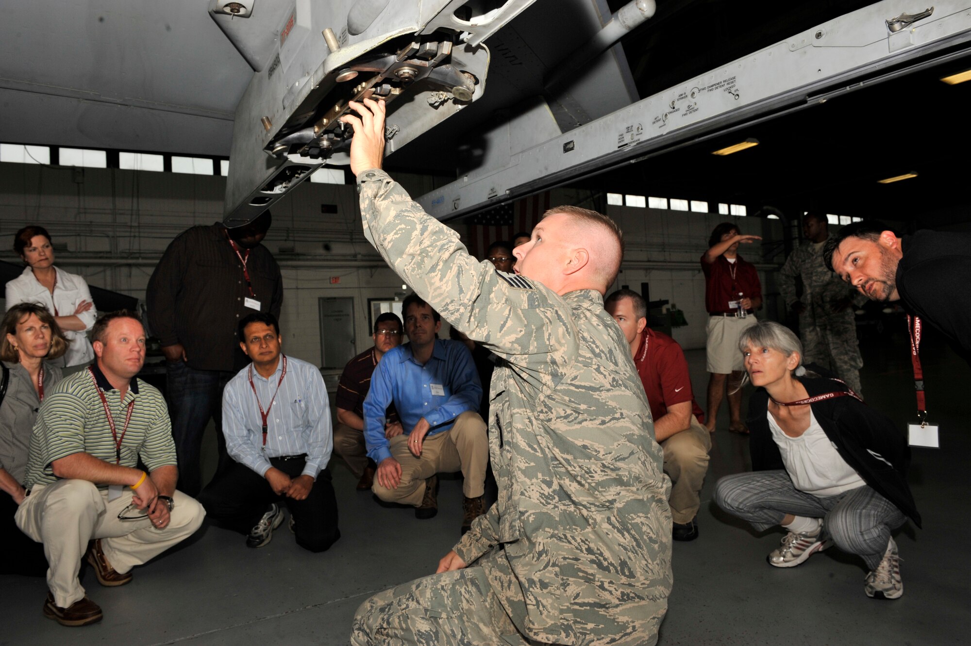 U.S. Air Force Staff Sgt. Daniel Grigg, 20th Maintenance Group lead crew member, shows members of University of South Carolina's Carolina Nexus the 129 launcher on the wing of an F-16 at Shaw Air Force Base, S.C., May 14, 2012. Carolina Nexus visited Shaw AFB during a five-day bus tour viewing popular landmarks around South Carolina. (U.S. Air Force photo by Senior Airman Tabatha McCarthy/released)