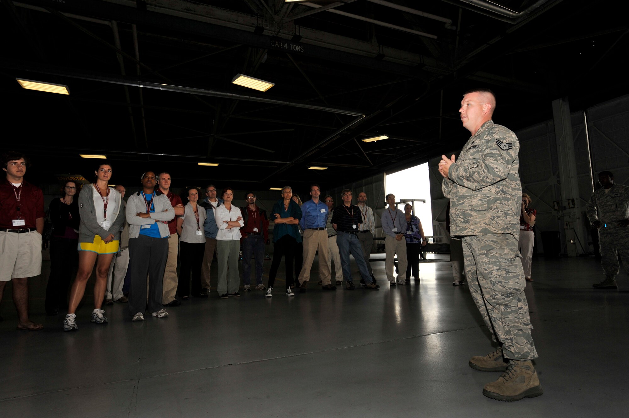 U.S. Air Force Staff Sgt. Daniel Grigg, 20th Maintenance Group lead crew member, welcomes University of South Carolina's Carolina Nexus members to the load barn at Shaw Air Force Base, S.C., May 14, 2012. The Carolina Nexus program visited Shaw AFB during a five-day bus tour showing new faculty members of popular landmarks around South Carolina. (U.S. Air Force photo by Senior Airman Tabatha McCarthy/released)