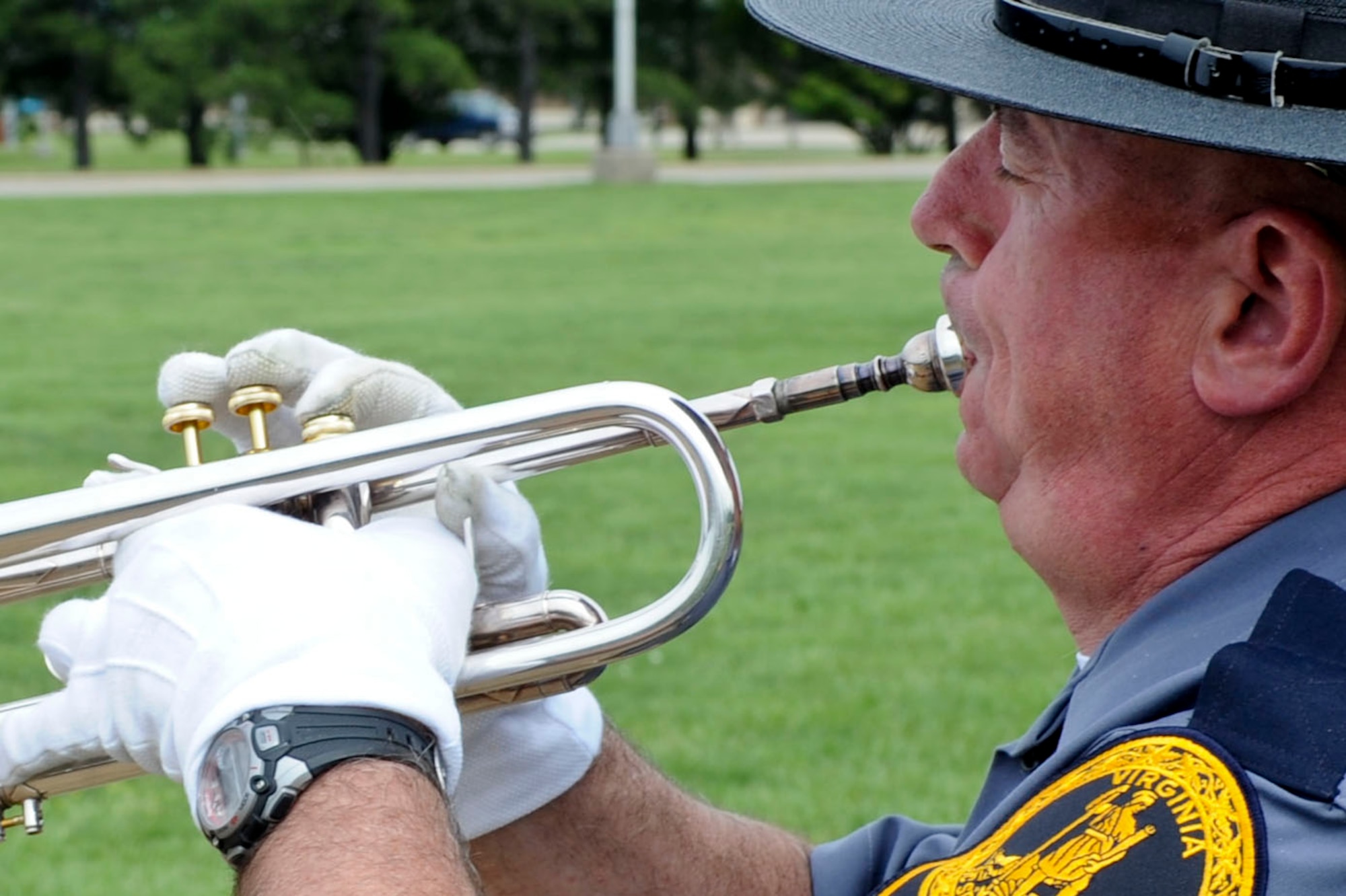 Virginia State Police trooper John Lafond plays taps during a retreat ceremony at Langley Air Force Base, Va., May 14, 2012. The ceremony was held to remember the 145 civilian and military police officers who lost their lives in the last 12 months. (U.S. Air Force photo by Senior Airman Wesley Farnsworth/Released)