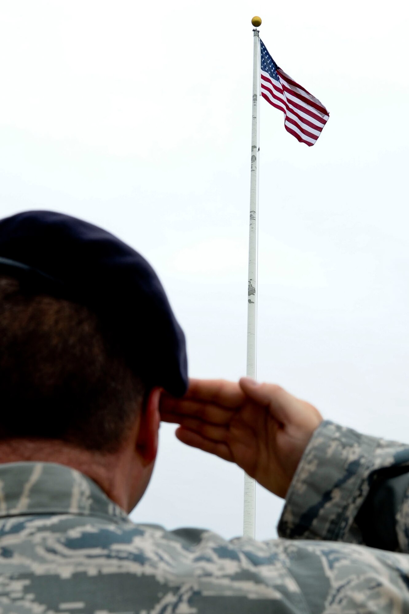 A 633rd Air Base Wing Security Forces member renders a salute during the playing of the National Anthem at the Police Remembrance Retreat at Langley Air Force Base, Va., May 14, 2012.The ceremony was held to honor all policemen who lost their lives in the line of duty. (U.S. Air Force photo by Senior Airman Wesley Farnsworth/Released)
