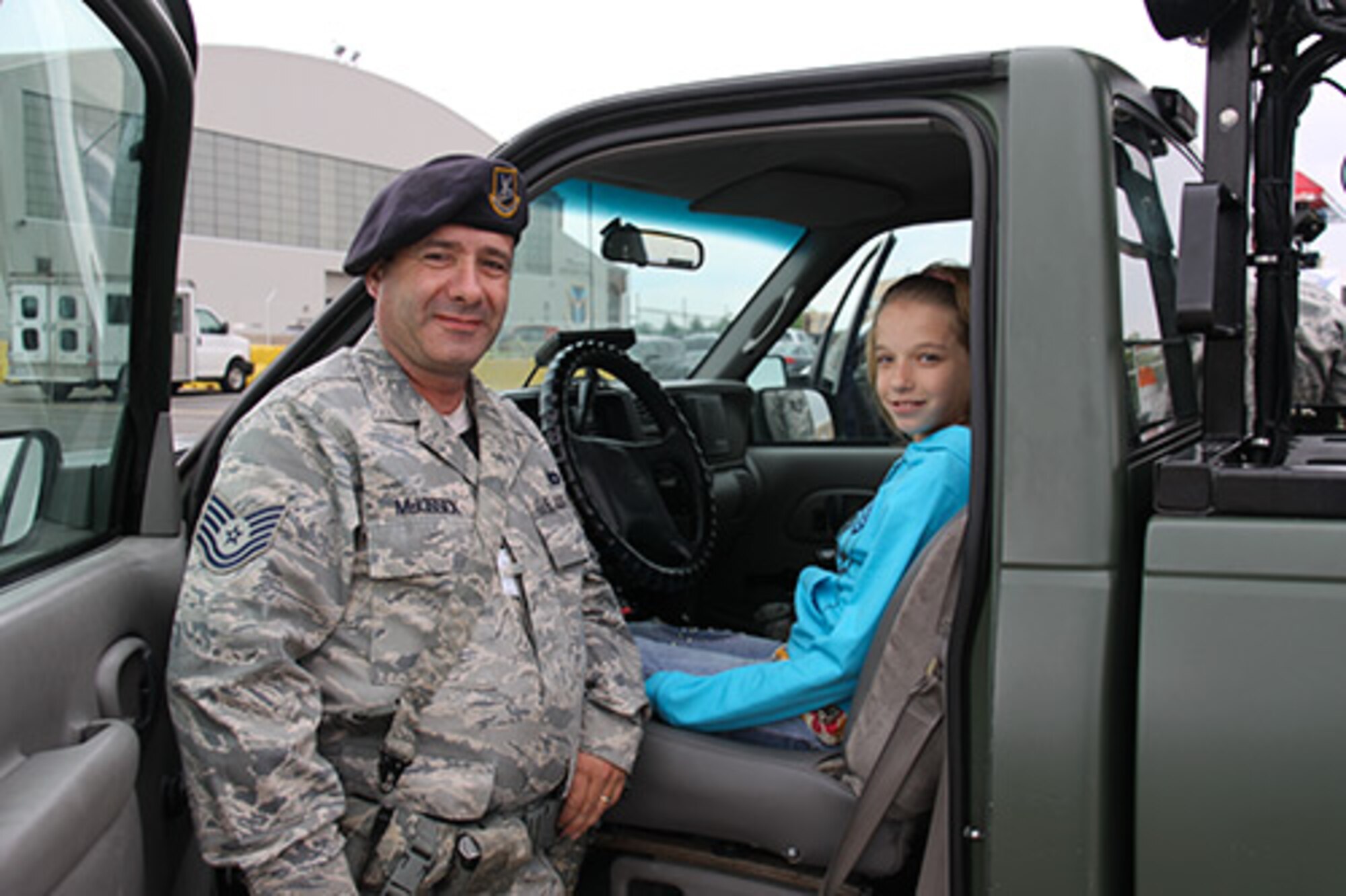 Tech. Sgt. Douglas McKissick, a patrolman attached to the 911th Airlift Wing Security Forces Squadron, shows Sarah Young of Pittsburgh, Pa., one of the 911th SFS patrol vehicles on the 911th flight line, May 14, 2012. Young visited the base to deliver 51 personally handcrafted military rosaries to Airmen here.  Since November 2011, with the help of her church, she has constructed and sent almost 200 rosaries to troops overseas. (U.S. Air Force photo by Airman 1st Class Justyne Obeldobel/Released)
