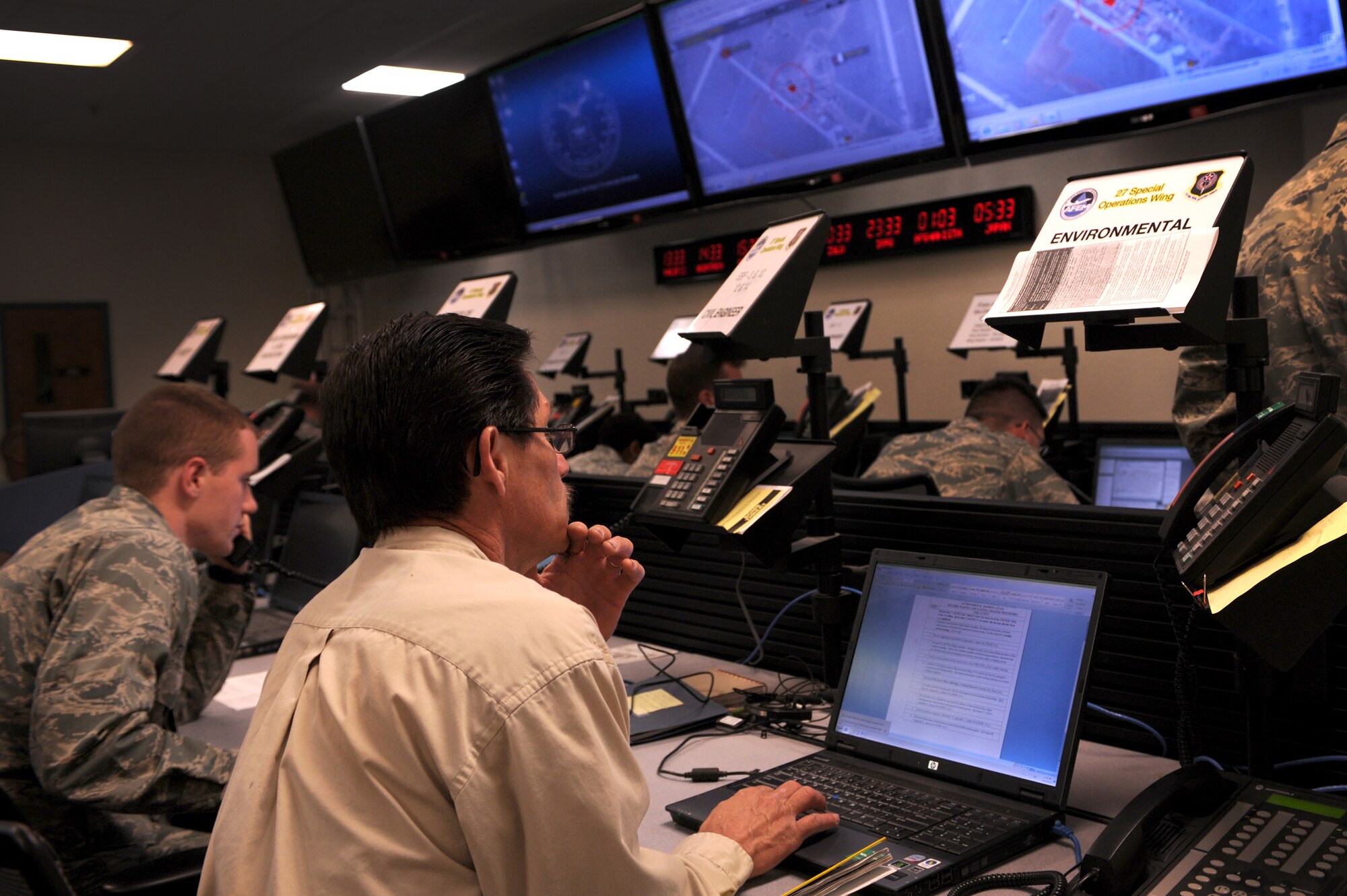 Base personnel in the Emergency Operations Center respond to a simulated tornado during an exercise at Cannon Air Force Base, N.M., May 10, 2012. The EOC works as a hub for multiple agencies to respond and make decisions during emergencies.  (U.S. Air Force photo by Senior Airman James Bell)