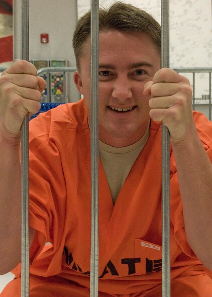 Tech. Sgt. Howard Taylor, 372nd Training Squadron, waits in a make-shift prison at the base exchange during a jail-and-bail fundraiser May 15, 2012, at Dyess Air Force Base, Texas. The fundraiser allowed airmen to have military and civilian personnel from Dyess arrested and taken to the base exchange. The prisoners were held one minute for every dollar donated toward their arrest. The event was held during National Police Week, proclaimed by President John F. Kennedy in 1962, to honor those who have made the ultimate sacrifice. (U.S. Air Force photo by Airman 1st Class Damon Kasberg/Released)