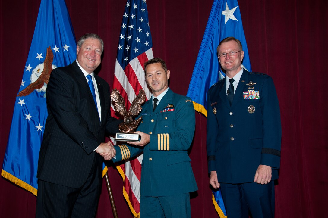 (From left to right) Secretary of the Air Force Michael Donley presents the 2012 Secretary of the Air Force Leadership Award to Air War College student Col. David Lowthian, Royal Canadian Air Force, while Lt. Gen. David Fadok, president and commander of the Air University, looks on during a ceremony May 11, 2012, at Maxwell Air Force Base, Ala. Lowthian was the first Air University international student to receive the award, which is the Air Force’s most prestigious award for leadership in the professional military education environment. In addition to Lowthian, Donley presented the award to three other Airmen attending Air Command and Staff College, Squadron Officer School, and the Senior Noncommissioned Officer Academy, respectively. (Air Force photo by Melanie Rodgers-Cox)