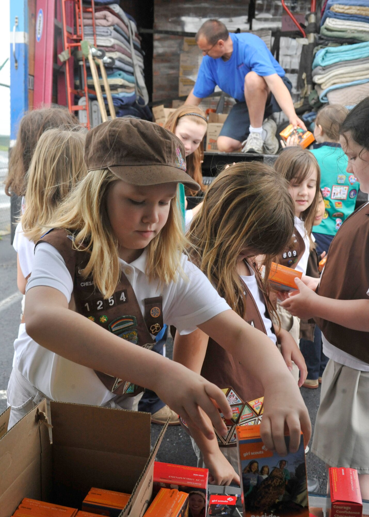 Girl Scouts load cookies into a van May 9, 2012, at the Air Mobility Command Museum on Dover Air Force Base, Del. The Girl Scouts delivered cookies to the United Services Organization as part of the USO Operation Taste of Home cookie drop which supports military members worldwide. (U.S. Air Force photo by Tech. Sgt. Chuck Walker)