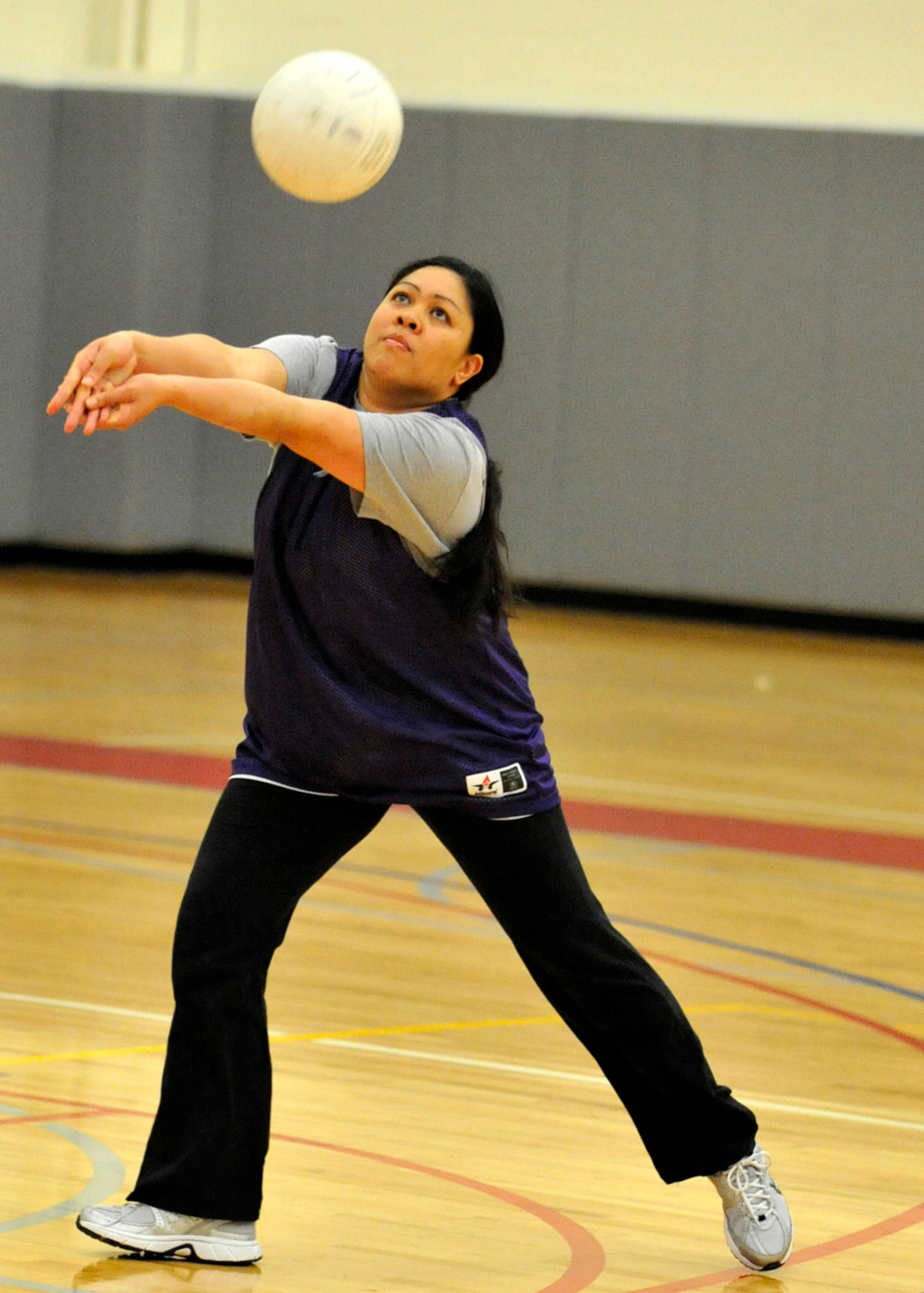 Jolene Lu of the 736th Aircraft Maintenance Squadron digs a shot during an intramural volleyball playoff match against the 436th Operations Group May 14, 2012, at the Fitness Center on Dover Air Force Base, Del. The 736th AMXS swept the first-round matchup 25-12 and 25-18. (U.S. Air Force photo by Tech. Sgt. Chuck Walker)