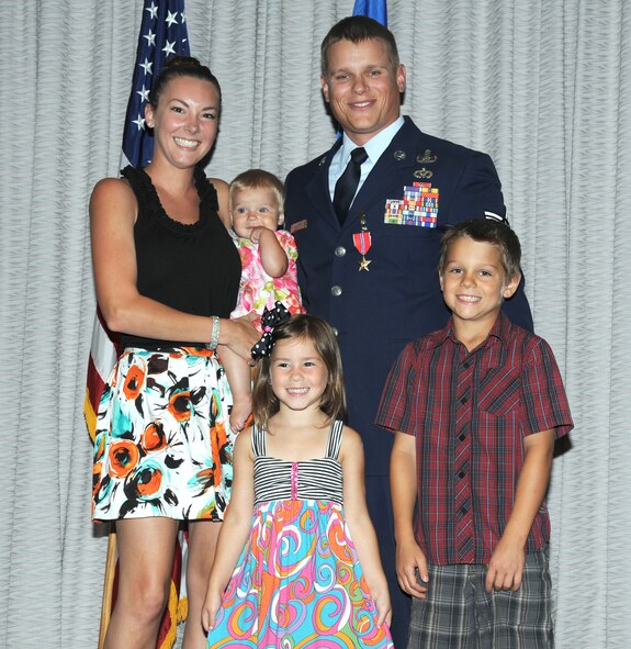 Bronze star recipient,Tech.Sgt. Ronnie "Bo" Brickey, poses with his family, wife Miko Brickey and children - Blake, 9, Lilly, 4, and Daisy, 6 months. Brickey, an explosive ordnance disposal technician, was presented his fourth Bronze Star April 27, 2012. 
(U.S. Air Force photo/Rachel Arroyo)
