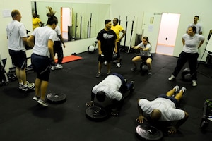 Airmen from the 633rd Force Support Squadron perform Crossfit exercises during their unit physical fitness session at the Langley Air Force Base, Va., Air Combat Command gym, May 15, 2012. Crossfit is a full-body workout meant to increase both physical and physiological tolerance. (U.S. Air Force photo by Senior Airman Wesley Farnsworth/Released)