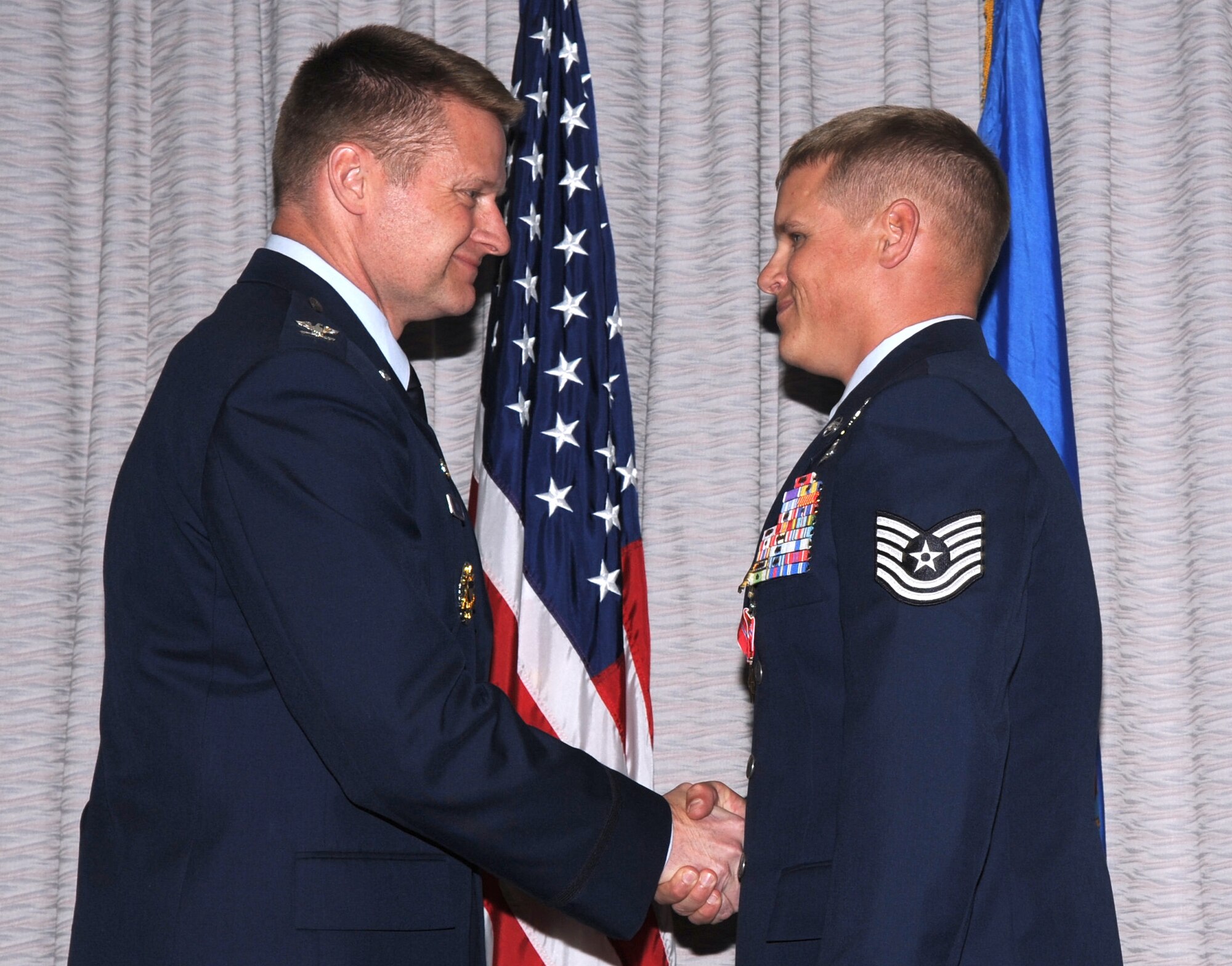 Colonel Eric Ray, Commandant of the United States Air Force Special Operations School, presents Technical Sgt. Ronnie "Bo" Brickey his fourth Bronze Star April 27, 2012.