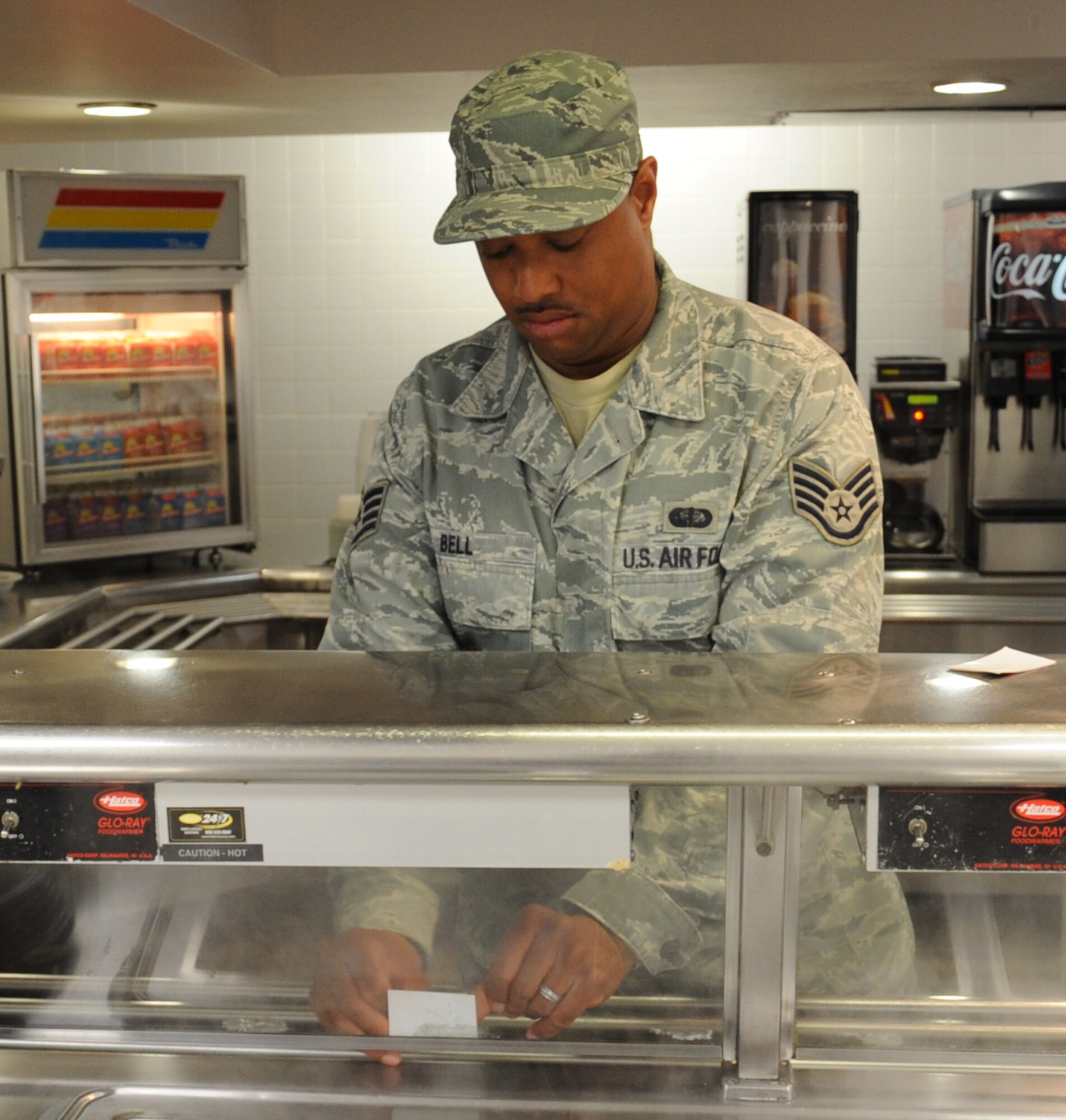 Staff Sgt. Charles Bell, 2nd Force Support Squadron food services shift leader, places labels on the serving line at the Red River Dining Facility on Barksdale Air Force Base, La., May 15. The dining facility is open for breakfast from 6 a.m. through 8 a.m., lunch from 11 a.m. through 1 p.m., dinner from 5 p.m. through 7 p.m., and a midnight meal during the weekends from 10:30 p.m. through midnight. (U.S. Air Force photo/Senior Airman Sean Martin)(RELEASED)
