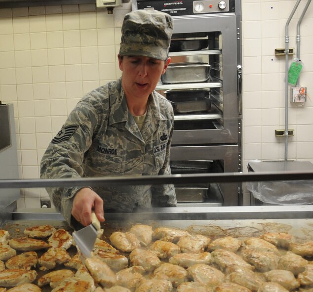 Tech. Sgt. Victoria Monroe, 2nd Force Support Squadron kitchen production manager, prepares chicken breasts at the Red River Dining Facility on Barksdale Air Force Base, La., May 15. The dining facility is available to all military members, officer and enlisted, DoD civilians on TDY or alert status, commanders, squadron section commanders, civilian and military of a foreign government, retirees and their immediate family members, deployed member's immediate family, and anyone in flight operations on official duty. (U.S. Air Force photo/Senior Airman Sean Martin)(RELEASED)
