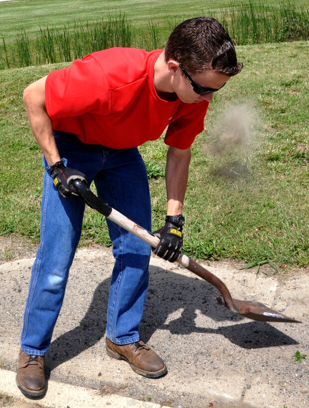 Charles Toplikar Jr., a Boy Scouts of America Troop 31 boy scout, shovels gravel away from a portion of the Air Combat Command running trail near the Eaglewood Golf Course May 12. Toplikar and other scouts from Troop 31 cleaned the trail on Langley Air Force Base, Va., for the safety of the runners. Toplikar must show leadership and delegation abilities to become an eagle scout, said James Gedville, the BSA Troop 31 assistant scout master. (U.S. Air Force photo by Airman 1st Class Austin Harvill/Released) 