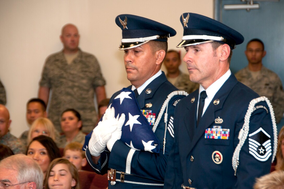 Tech. Sgt. Michael Brizuela, left, performs a flag folding ceremony at a military retirement at the 162nd Fighter Wing in Tucson, Ariz. Thirty years ago this Memorial Day he first signed up for Honor Guard duty and has steadily volunteered ever since. “I’m just grateful I can still do this all these years later. I want to be useful to the end and I hope I can even help post the colors at my own retirement one day,” Brizuela said. (U.S. Air Force photo/Master Sgt. Dave Neve)