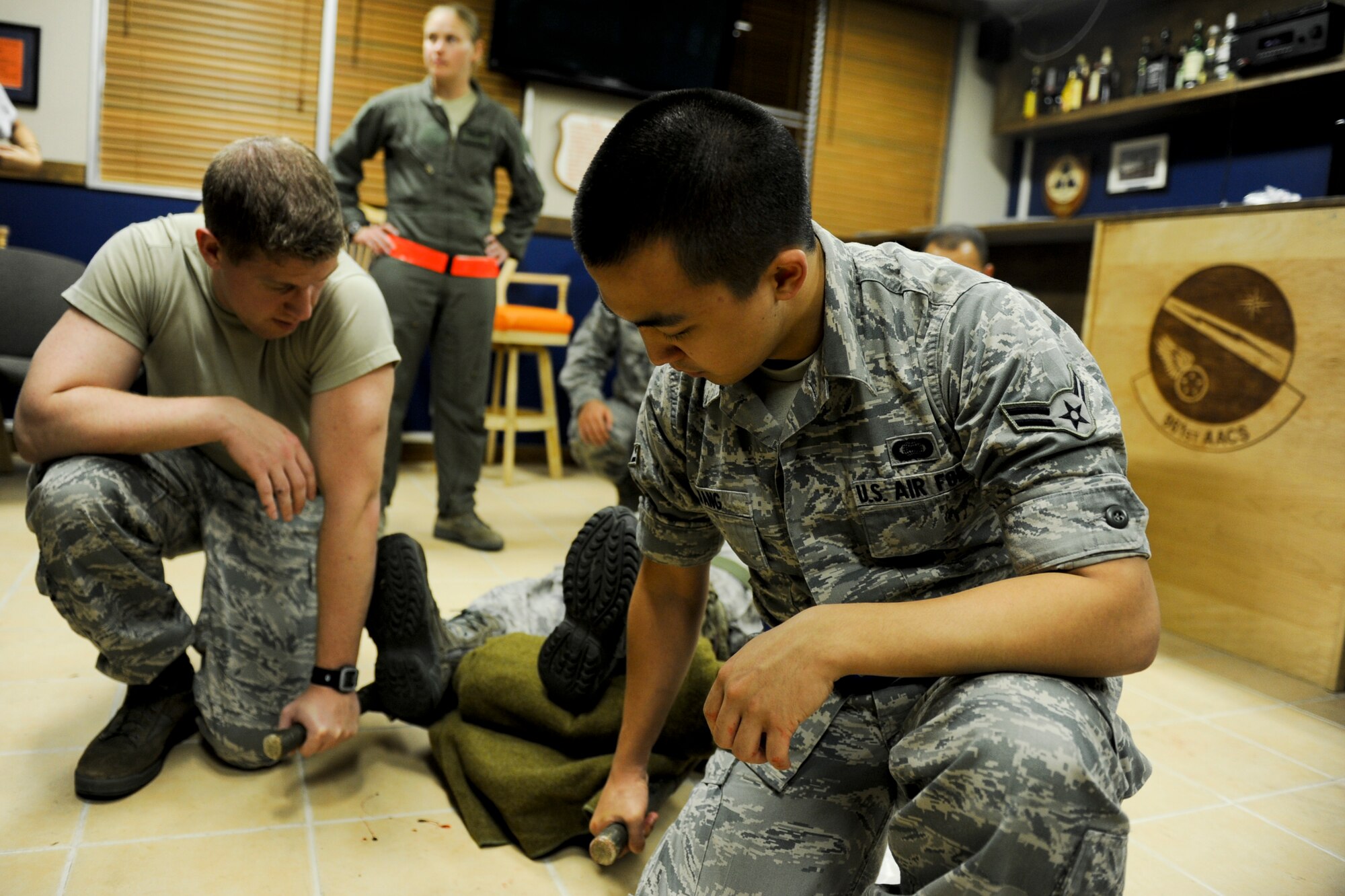 U.S. Air Force Airmen prepare to litter-carry a simulated victim during a self-aid and buddy care scenario during local operational readiness exercise Beverly High 12-4 on Kadena Air Base, Japan, May 15, 2012. LOREs are designed to test, train and evaluate the base's ability to respond to a contingency in the region. (U.S. Air Force photo/Airman 1st Class Brooke P. Beers)