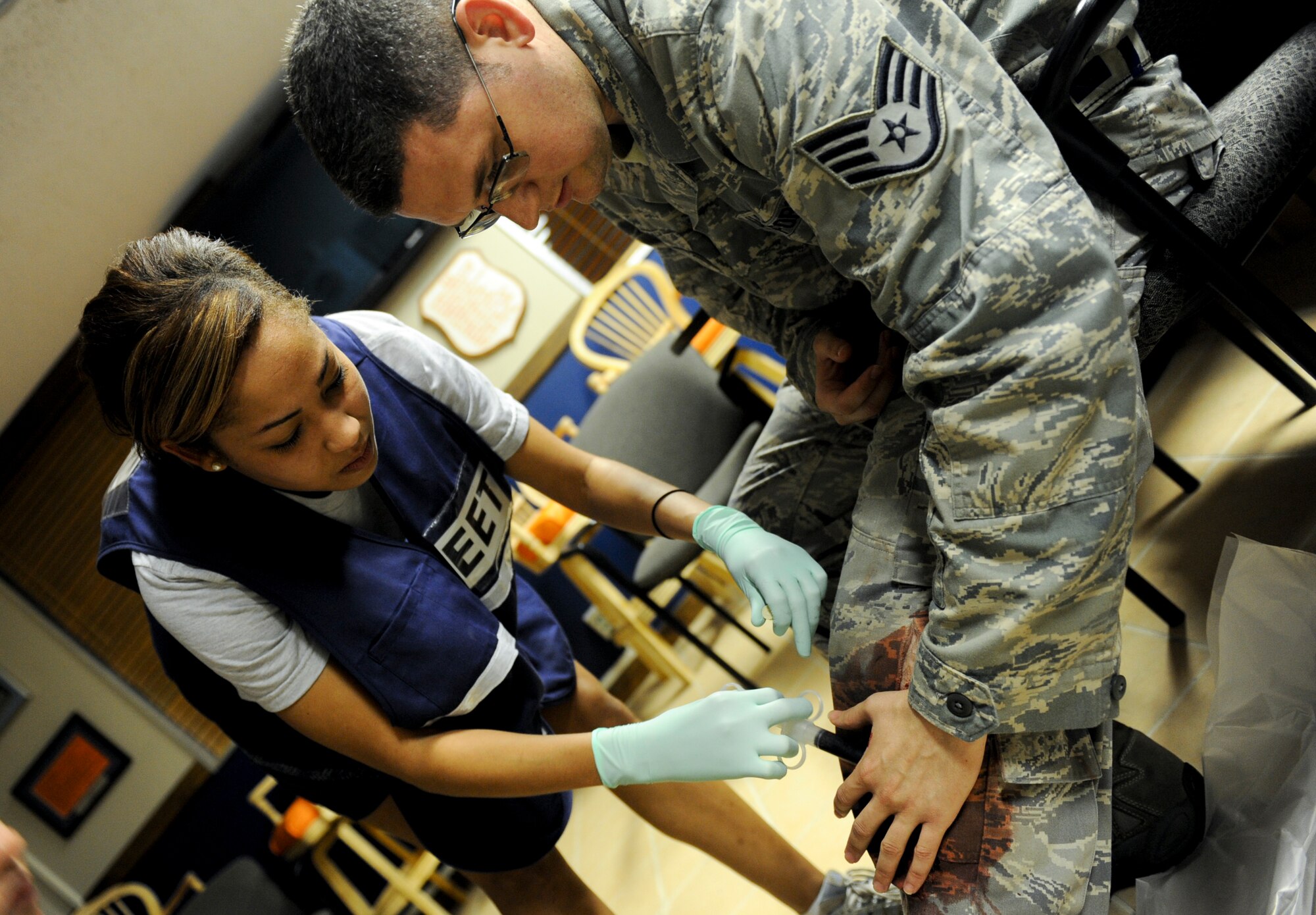 U.S. Air Force Staff Sgt. Britney Jones, 18th Dental Squadron dental journeyman, applies fake blood to U.S. Air Force Staff Sgt. Sean Lucas, 18th Aircraft Maintenance Squadron jet engine journeyman, for a training scenario during local operational readiness exercise Beverly High 12-4 on Kadena Air Base, Japan, May 15, 2012. It’s important to have scenarios that are as life-like as possible for Airmen to have more hands-on training in order to have a more in-depth understanding. (U.S. Air Force photo/Airman 1st Class Brooke P. Beers)
