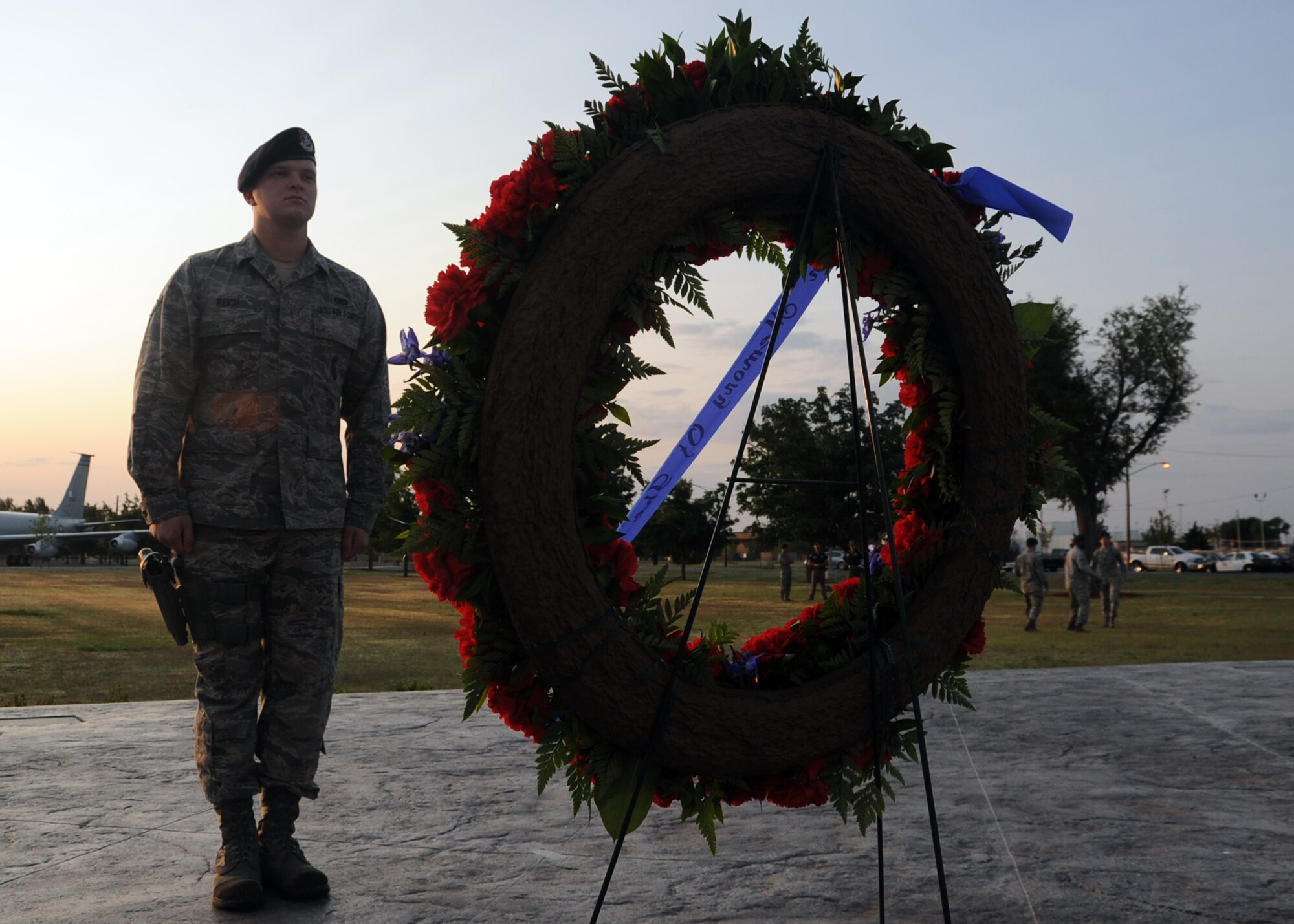 ALTUS AIR FORCE BASE, Okla. – Airman Daniel Reich, 97th Security Forces Squadron patrolman, guards a wreath after reveille at the Wings of Freedom Park, May 15, 2012. From sunrise to sunset security forces members performed hourly shifts to guard the wreath which honors law enforcement who gave their lives in the line of duty. (U.S. Air Force photo by Airman 1st Class Franklin R. Ramos / 97th Air Mobility Wing / Released)
