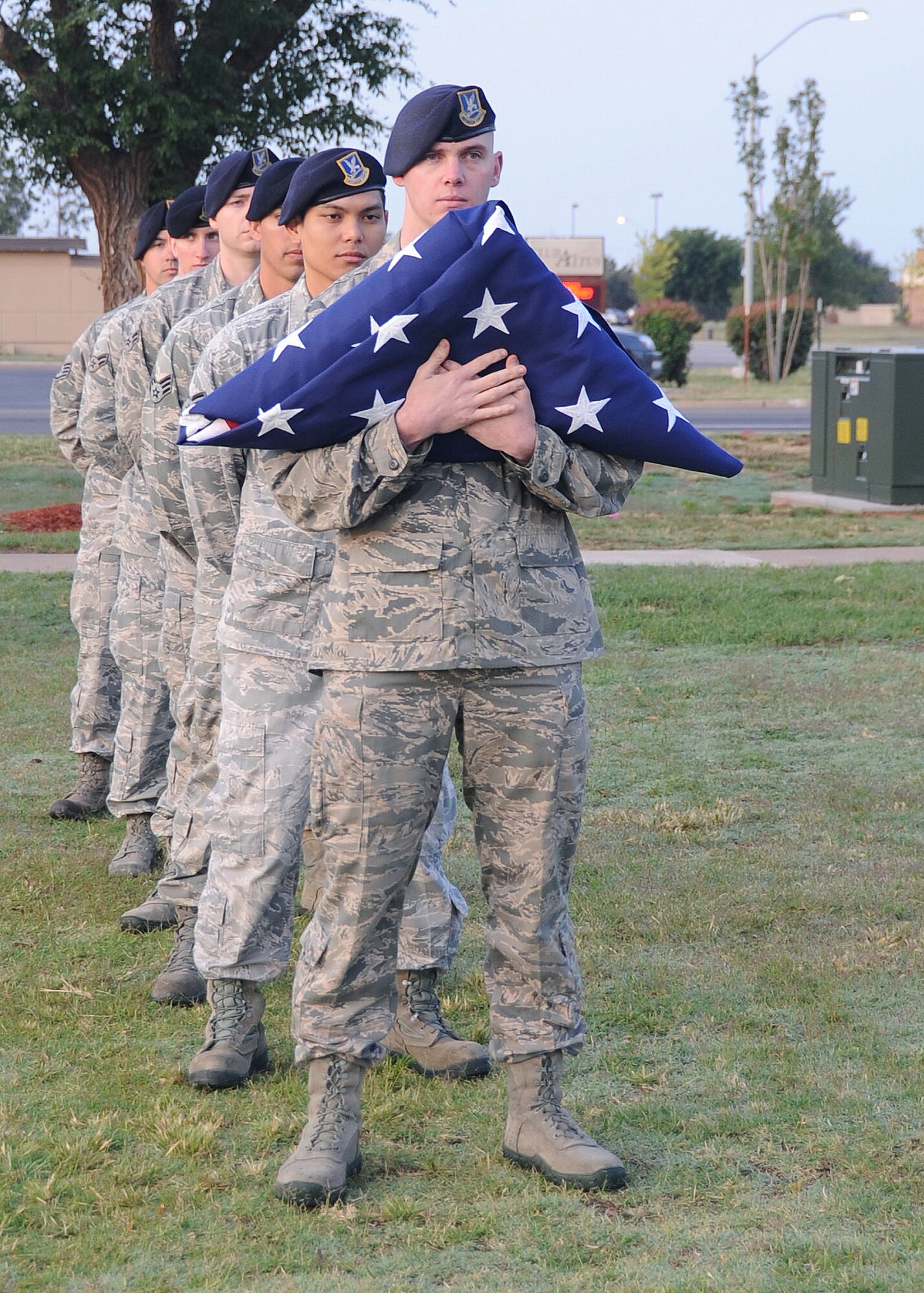 ALTUS AIR FORCE BASE, Okla. – Members of the 97th Security Forces Squadron prepare to raise the flag at reveille in honor of Police Week at the Wings of Freedom Park, May 15, 2012. In 1962 President John F. Kennedy designated this day to be National Peace Officers Day to honor officers who gave their lives in the line of duty. (U.S. Air Force photo by Airman 1st Class Franklin R. Ramos / 97th Air Mobility Wing / Released)