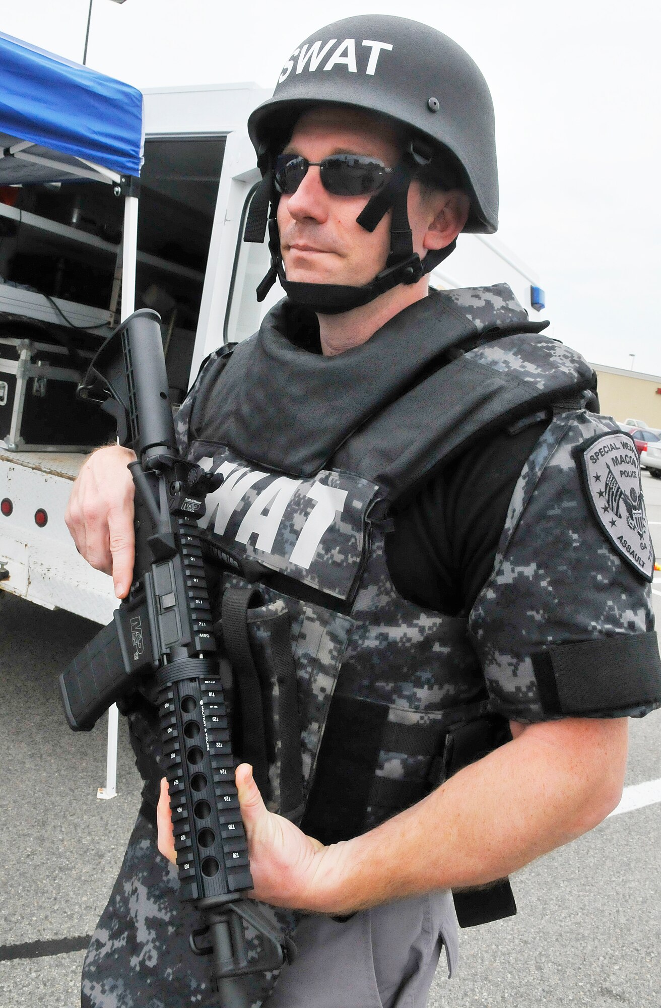 Robert Martin, a Sargent with the Macon Police Department SWAT team puts on his gear at the National Police Week display at Home Depot. Police Departments from Macon, Warner Robins, Centerville, Byron and Robins Air Force Base were represented at the event. Martin is also a Staff Sgt. with the 116th CES.(U. S. Air Force photo by Sue Sapp)