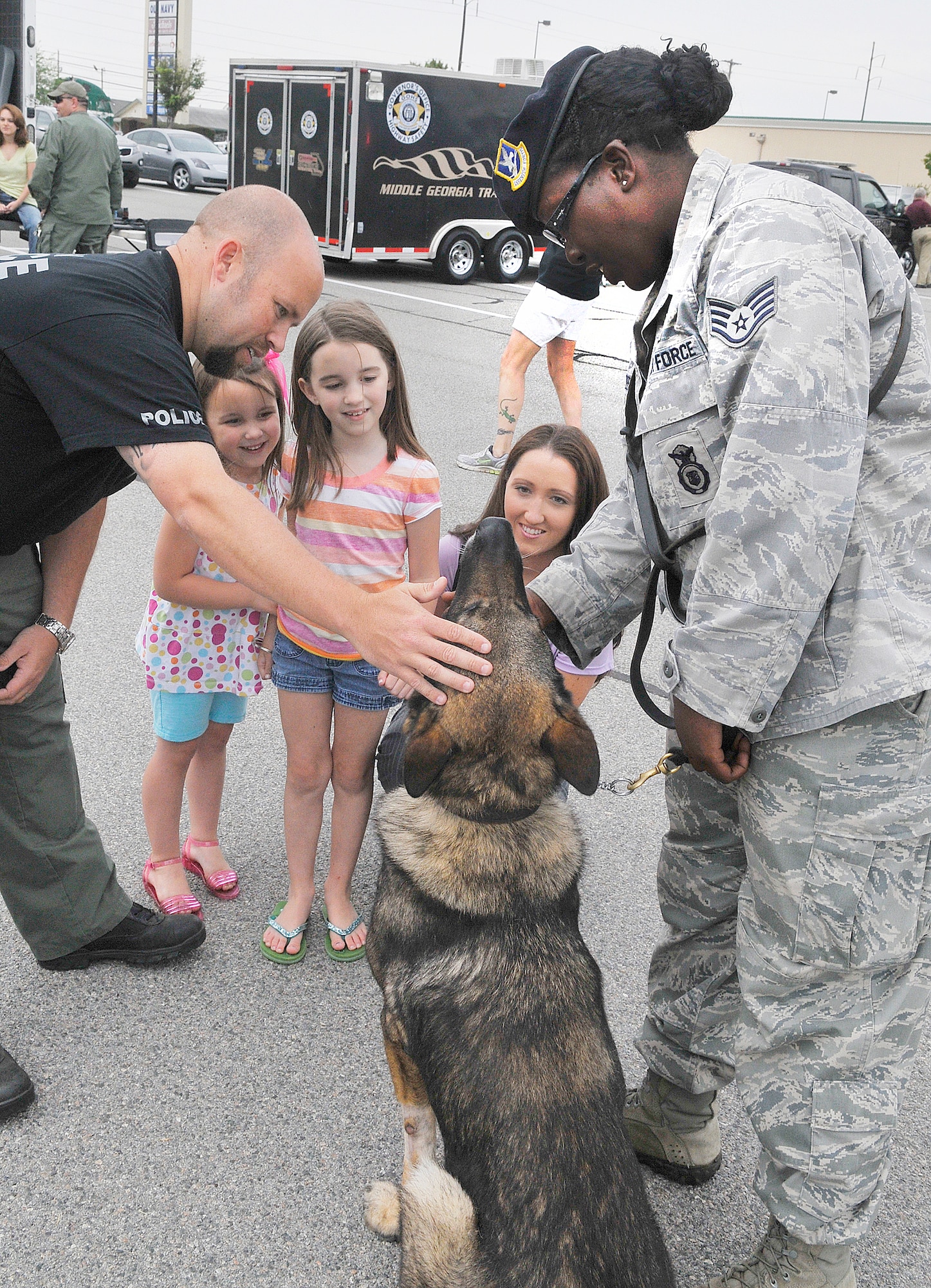 Jason, Madeline, Mary Catherine and Cassandra Maloy visit with Staff Sgt. Minie Green and Military Working Dog Mato at a display of local law enforcement agencies at Home Depot Saturday for National Police Week.  May 15 of each year is Peace Officers’ Memorial Day in honor of the officers who have given their lives in the line of duty.  The calendar week in which May 15 falls is National Police Week in recognition of the service given by the men and women who selflessly put their lives in harms way everyday.  (U. S. Air Force photo by Sue Sapp)