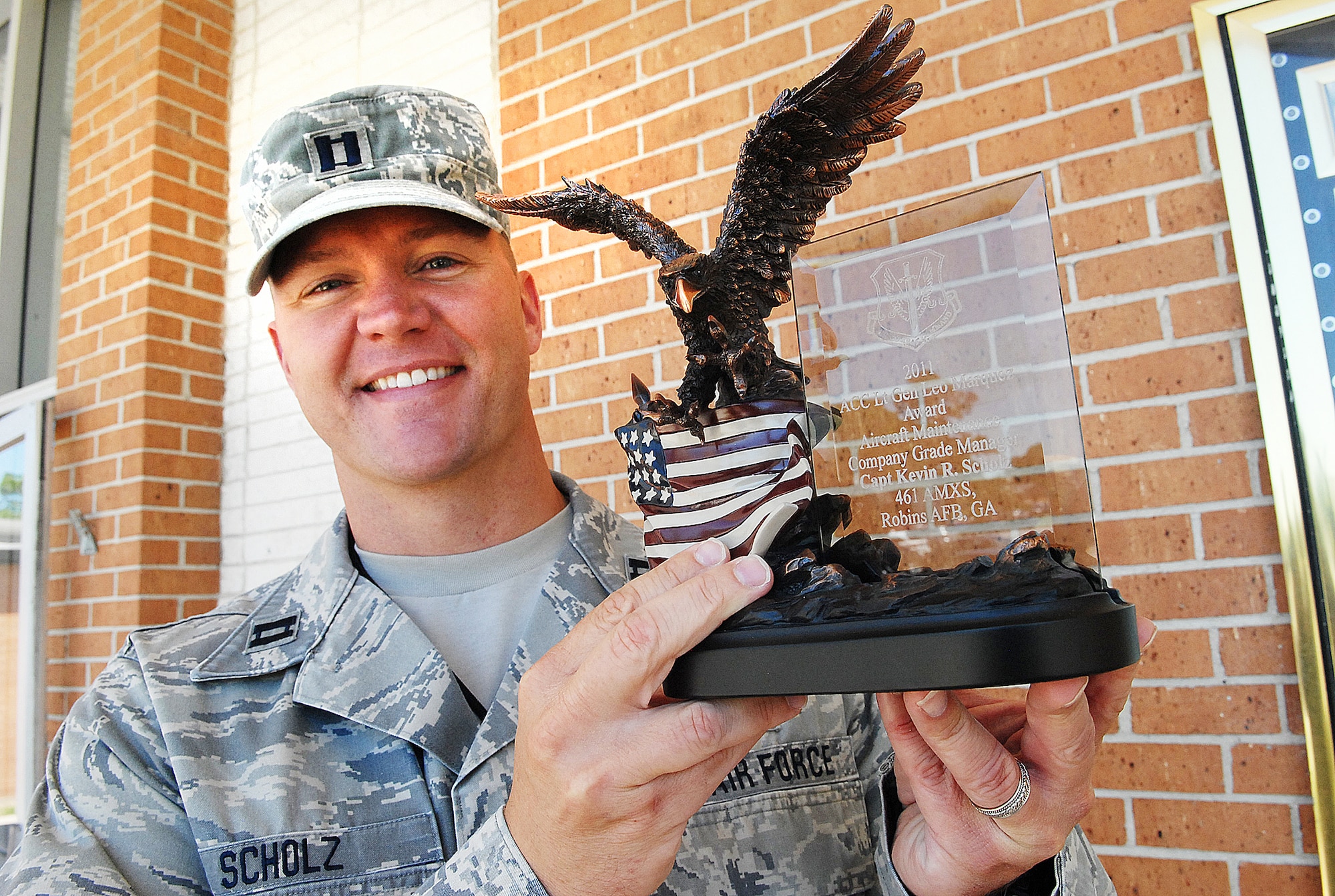 Capt. Kevin Scholz, a 461st Maintenance Squadron operations officer, shows off his 2011 Lt. Gen Leo Marquez award.(U. S. Air Force photo by Sue Sapp)