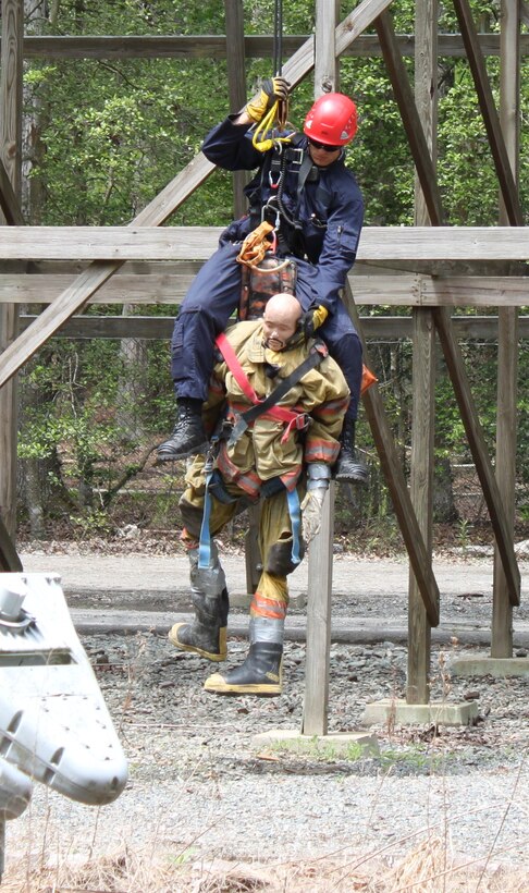 Maurice Carter, a Fort Eustis firefighter, retrieves a simulated victim from the grounds surrounding the Grizzly roller coaster during the 2012 Virginia State Rescue Challenge at Kings Dominion amusement park in Doswell, Va., May 7, 2012. Carter's scenario called for him to rescue a park maintenance technician that had fallen from the roller coaster track during a pre-ride inspection. (U.S. Army photo by Bryan Anthony/Released)