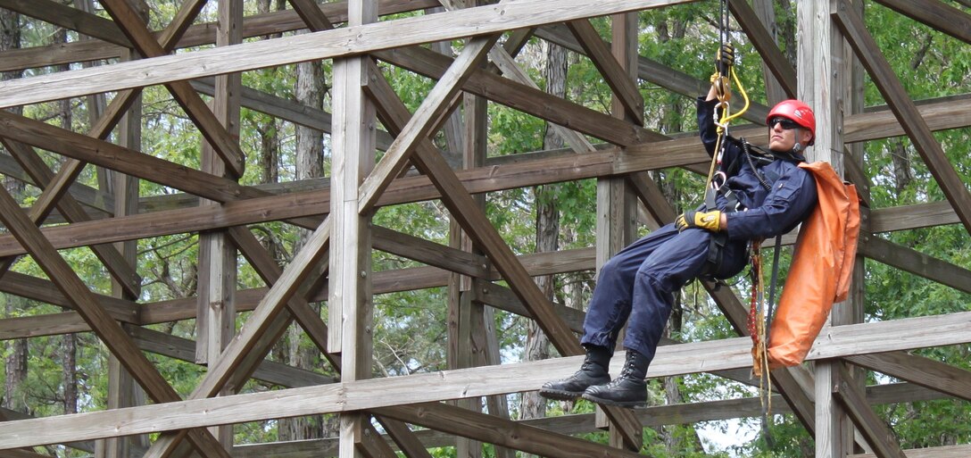 Maurice Carter, a Fort Eustis firefighter, descends from the Grizzly roller coaster to rescue a simulated victim during the 2012 Virginia State Rescue Challenge at Kings Dominion amusement park in Doswell, Va., May 7, 2012. The scenarios included high-angle rope rescue, confined space rescue, vehicle passenger extraction and rescue and building collapse rescues, among others. (U.S. Army photo by Bryan Anthony/Released)