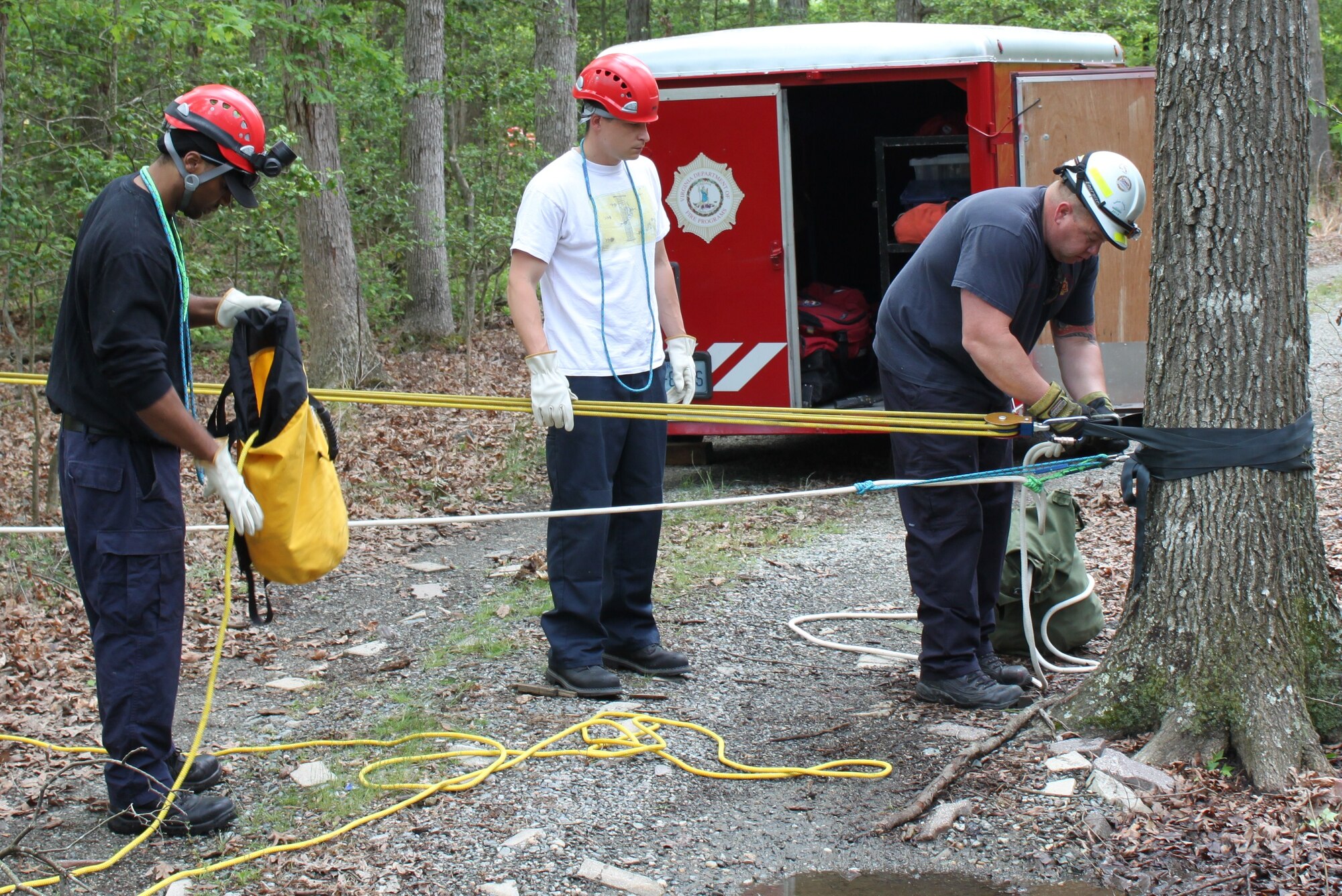 (From left) Fort Eustis firefighters Jason Percy, Charles Hunt and station chief Christopher Collius set up a haul system to deploy a rescuer down to save a potential victim during the 2012 Virginia State Rescue Challenge at Kings Dominion amusement park in Doswell, Va., May 7, 2012. The week-long exercise tested the abilities of technical rescue operators from across the state in a variety of difficult rescue scenarios. (U.S. Army photo by Bryan Anthony/Released)