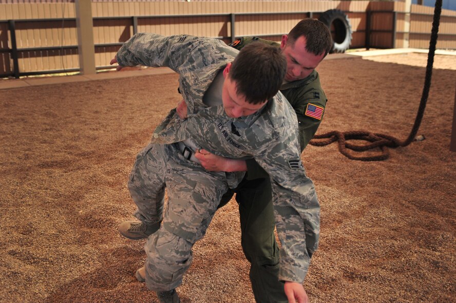 A U.S. Air Force aircrew member practices a take-down maneuver against his sparring partner during a specialized Survival, Evasion, Resistance, and Escape lesson at Cannon Air Force Base, N.M., May 2, 2012. SERE training is necessary for select Cannon Air Force Base, N.M., personnel to maintain mission-ready status. (U.S. Air Force photo by Airman 1st Class Alexxis Pons Abascal)  