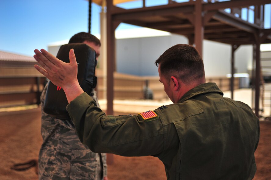 A U.S. Air Force aircrew member spars with his partner during a specialized Survival, Evasion, Resistance, and Escape lesson at Cannon Air Force Base, N.M., May 2, 2012. SERE training is necessary for select Cannon Air Force Base, N.M., personnel to maintain mission-ready status. (U.S. Air Force photo by Airman 1st Class Alexxis Pons Abascal)  