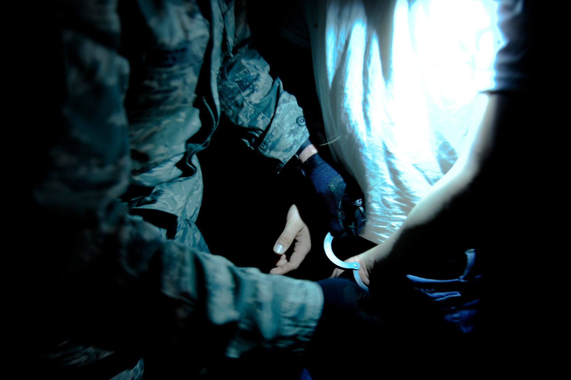 U.S. Air Force Staff Sgt. Robert West, 18th Security Forces Squadron response force leader, handcuffs U.S. Air Force Airman 1st Class Andrew Chilcoat, 733rd Air Mobility Squadron air freight specialist and simulated robbery suspect, during local operational readiness exercise Beverly High 12-4 on Kadena Air Base, Japan, May 14, 2012. The training which began May 14, is designed to test the skills of Kadena's Airmen in a multitude of scenarios ranging from armed robberies to simulated base attacks. (U.S. Air Force photo/Airman 1st Class Maeson L. Elleman)