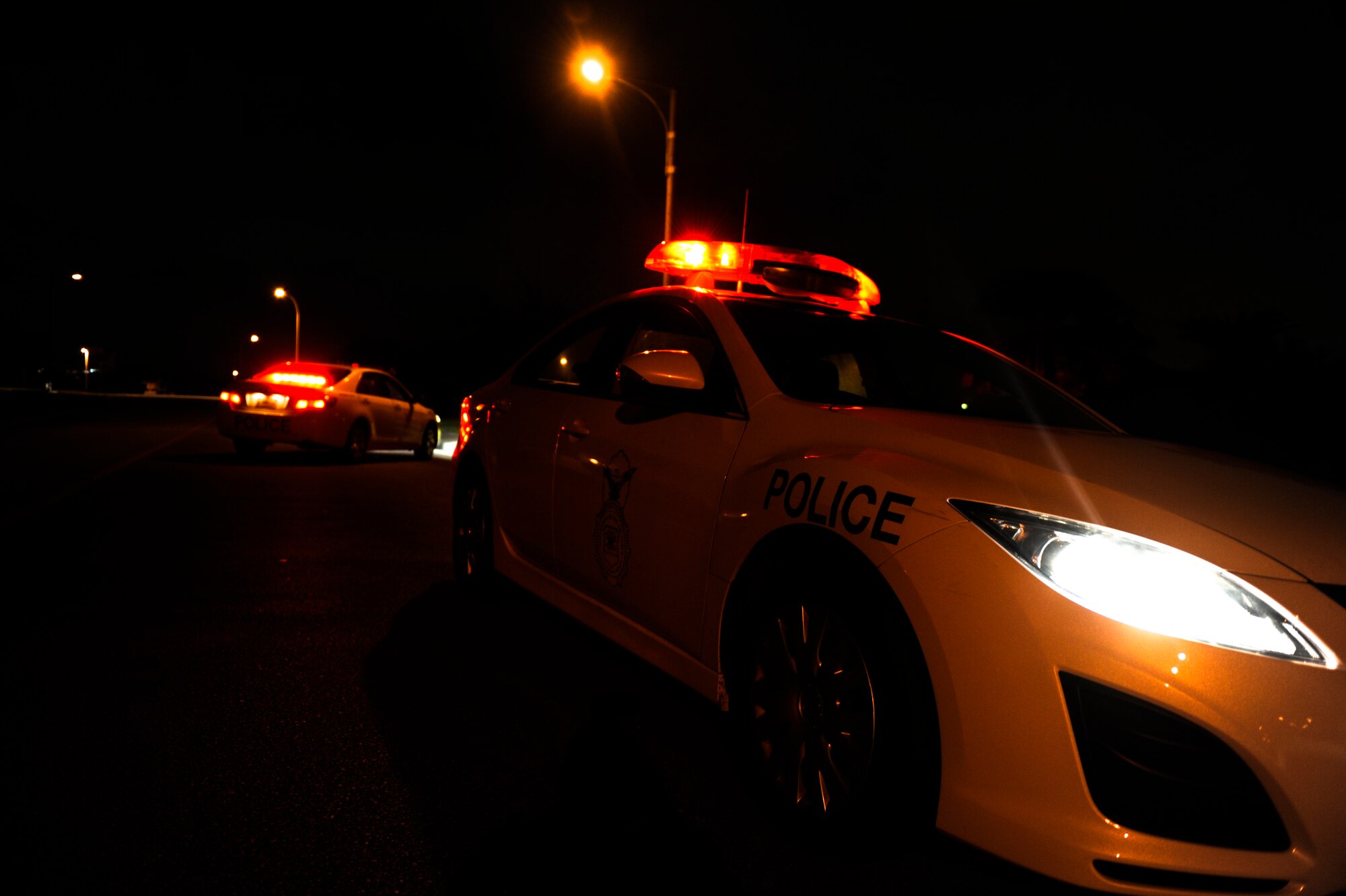 18th Security Forces Squadron members station patrol cars in the street to halt traffic during an armed robbery scenario as part of Beverly High 12-4, a local operational readiness exercise on Kadena Air Base, Japan, May 14, 2012. During the scenario, response force members from 18th SFS trained on their ability to locate, disarm and arrest the armed robber. (U.S. Air Force photo/Airman 1st Class Maeson L. Elleman)