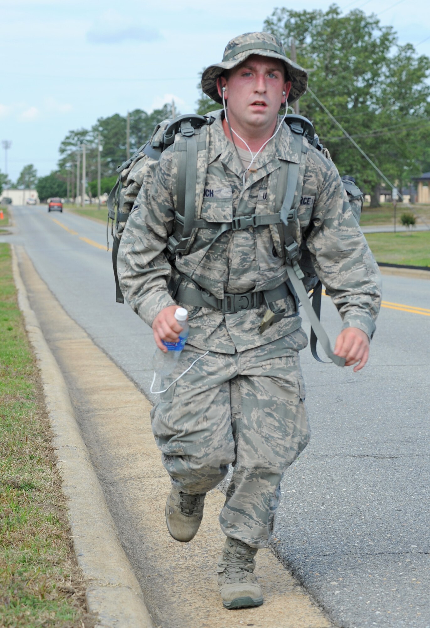 U.S. Air Force Airman Joseph Lynch runs during the 4th Security Forces ruck march for National Police Week on Seymour Johnson Air Force Base, N.C., May 14, 2012. In 1962, President John F. Kennedy signed a proclamation designating May 15 as Peace Officers Memorial Day and the week surrounding that date is recognized as Police Week. Lynch, 4th SFS patrolman, hails from Boston. (U.S. Air Force photo/Senior Airman Gino Reyes/Released)

